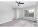 Bright bedroom featuring neutral walls, carpet, ceiling fan and a window providing ample natural light at 4036 Meadowview Hills Dr # 7, Charlotte, NC 28269