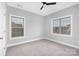 Cozy bedroom with neutral walls, plush carpet, large windows that flood the space with light, and a ceiling fan at 4036 Meadowview Hills Dr # 7, Charlotte, NC 28269