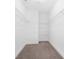 Spacious walk-in closet with custom shelving and carpet flooring providing efficient storage solutions at 4036 Meadowview Hills Dr # 7, Charlotte, NC 28269