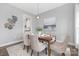 Cozy dining area with modern light fixture and seating for six at 4036 Meadowview Hills Dr # 7, Charlotte, NC 28269