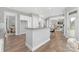 Well-lit kitchen with an island, granite countertops, and an open view to the living room at 4036 Meadowview Hills Dr # 7, Charlotte, NC 28269