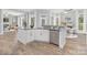 Modern kitchen island with granite countertops, white cabinets, and stainless steel appliances at 4036 Meadowview Hills Dr # 7, Charlotte, NC 28269