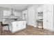 Modern kitchen with white cabinets, an island with seating, and stainless steel appliances at 4036 Meadowview Hills Dr # 7, Charlotte, NC 28269