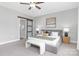 Well-lit main bedroom boasts a barn door, ceiling fan, and plush carpeting at 4036 Meadowview Hills Dr # 7, Charlotte, NC 28269
