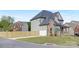 View of the home's side showcasing the attached garage and backyard fencing at 4036 Meadowview Hills Dr # 7, Charlotte, NC 28269