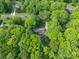 Aerial view of the property surrounded by lush, mature trees, offering privacy and a serene setting at 4256 Wood Forest Dr, Rock Hill, SC 29732