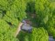Overhead view of property showcasing the home, detached garage, driveway, and surrounding wooded area at 4256 Wood Forest Dr, Rock Hill, SC 29732