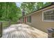 Backyard deck with wooden railing, red door, and lush green trees at 4256 Wood Forest Dr, Rock Hill, SC 29732