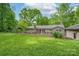 Backyard featuring a deck and well-manicured lawn surrounded by lush greenery at 4256 Wood Forest Dr, Rock Hill, SC 29732