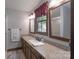 Bathroom showcasing an extended granite countertop, vanity with sink, framed mirrors, and a shower at 4256 Wood Forest Dr, Rock Hill, SC 29732