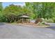 Community entrance featuring a decorative sign, gazebo, and lush landscaping, creating a welcoming atmosphere at 4256 Wood Forest Dr, Rock Hill, SC 29732