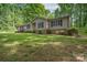 Inviting home exterior with lush green lawn and mature landscaping, providing excellent curb appeal at 4256 Wood Forest Dr, Rock Hill, SC 29732