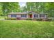 Charming single story home featuring a well-manicured lawn and a welcoming red front door at 4256 Wood Forest Dr, Rock Hill, SC 29732