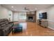 Inviting living room featuring wood floors and a brick fireplace at 4256 Wood Forest Dr, Rock Hill, SC 29732