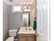 Functional half bathroom featuring wood cabinets and a simple design at 4743 Morning Dew Ct # 4743, Charlotte, NC 28269