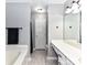 Bright bathroom featuring a vanity and tub at 4743 Morning Dew Ct # 4743, Charlotte, NC 28269