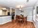 Inviting dining room with wood floors, a traditional chandelier, and natural light at 4743 Morning Dew Ct # 4743, Charlotte, NC 28269