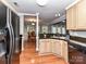 Functional kitchen with black appliances, wood cabinets, and wood flooring at 4743 Morning Dew Ct # 4743, Charlotte, NC 28269