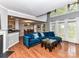 Open concept living room and dining room with a cozy blue velvet sofa at 4743 Morning Dew Ct # 4743, Charlotte, NC 28269