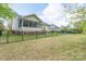 Large backyard with black metal fencing and glimpses of a screened in porch at 5135 Norway Ln, Rock Hill, SC 29732