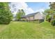 Spacious backyard with black iron fence and a view of the home's screened-in porch at 5135 Norway Ln, Rock Hill, SC 29732
