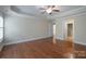 A bright bedroom features hardwood floors, a ceiling fan, and a view into the ensuite bathroom at 5135 Norway Ln, Rock Hill, SC 29732