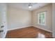 A comfortable bedroom offers hardwood floors, one window with white shutters, and a ceiling fan at 5135 Norway Ln, Rock Hill, SC 29732