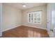 An airy bedroom features hardwood floors, one window with white trim and a ceiling fan at 5135 Norway Ln, Rock Hill, SC 29732