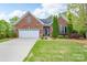 Charming brick home featuring a two-car garage and manicured lawn at 5135 Norway Ln, Rock Hill, SC 29732