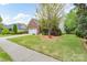 Well-maintained home boasts a lush front yard, mature landscaping, and brick accents at 5135 Norway Ln, Rock Hill, SC 29732