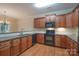 Well-appointed kitchen with granite countertops, stainless appliances, and warm wood cabinetry at 5135 Norway Ln, Rock Hill, SC 29732