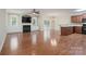 Spacious living room featuring a fireplace, hardwood floors, and adjacent kitchen area at 5135 Norway Ln, Rock Hill, SC 29732