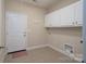 Functional mudroom with tiled floors, storage cabinets, and an exterior door at 5135 Norway Ln, Rock Hill, SC 29732