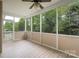 Relaxing screened porch with ceiling fan and peaceful view of the backyard at 5135 Norway Ln, Rock Hill, SC 29732
