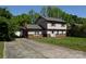 Two-story home features a covered carport and a spacious driveway at 5915 Bluebonnet Rd, Charlotte, NC 28212
