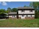 Charming two-story home with a lovely front lawn and a covered carport on a sunny day at 5915 Bluebonnet Rd, Charlotte, NC 28212