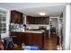 Kitchen with dark cabinets, an island, stainless steel appliances, and hardwood floors at 5915 Bluebonnet Rd, Charlotte, NC 28212