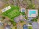 Aerial view of community amenities including a pool, playground, and parking area surrounded by greenery at 609 Tysons Forest Dr, Rock Hill, SC 29732