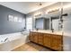 Bathroom features a tub, double sink vanity, and wood-look floors at 609 Tysons Forest Dr, Rock Hill, SC 29732