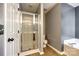 Bathroom boasts a glass-enclosed shower with wood-look flooring and gray walls at 609 Tysons Forest Dr, Rock Hill, SC 29732