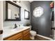 Well-lit bathroom with a black-framed mirror, unique decor, and a corner octagonal window at 609 Tysons Forest Dr, Rock Hill, SC 29732