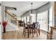 Bright eat-in kitchen with wood table, modern lighting, many windows, and staircase at 609 Tysons Forest Dr, Rock Hill, SC 29732