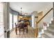 Eat-in kitchen features light-toned floors, wood table, stainless steel appliances, and stair access at 609 Tysons Forest Dr, Rock Hill, SC 29732