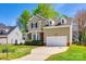 Charming two-story home boasts well-manicured lawn, brick accents, and attached garage under bright blue skies at 609 Tysons Forest Dr, Rock Hill, SC 29732