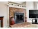 A classic brick fireplace serves as a focal point, adding warmth and character to the living space at 609 Tysons Forest Dr, Rock Hill, SC 29732