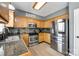 Well-equipped kitchen features stainless steel appliances, granite countertops, and oak cabinetry at 609 Tysons Forest Dr, Rock Hill, SC 29732
