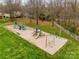 Aerial view of community playground with swings, slides, and climbing structure, nestled among mature trees at 609 Tysons Forest Dr, Rock Hill, SC 29732