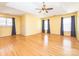 Spacious bedroom with tray ceiling, ceiling fan, hardwood floors and three large windows at 6123 Glen Manor Dr, Charlotte, NC 28269