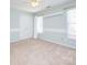 Bright bedroom features neutral carpeting, wainscoting, and a double door closet at 6123 Glen Manor Dr, Charlotte, NC 28269