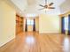 Large bedroom featuring hardwood floors, a tray ceiling, and a ceiling fan at 6123 Glen Manor Dr, Charlotte, NC 28269